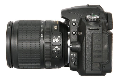 Nikon D90 DSLR camera with zoom lens on white background.
