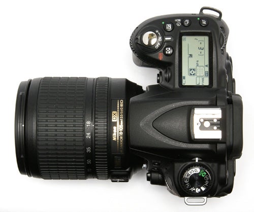 Nikon D90 DSLR camera with lens on white background.
