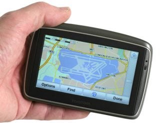 Hand holding TomTom GO 540 LIVE with map displayed.