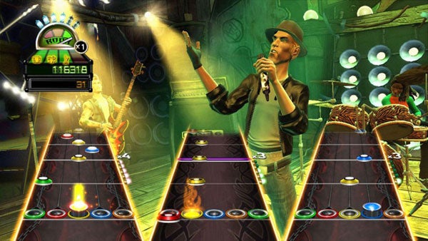 Screenshot of Guitar Hero World Tour gameplay with band avatars.