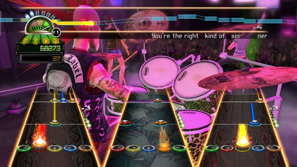 Guitar Hero: World Tour gameplay screenshot with drum kit.