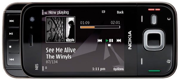 Nokia N85 smartphone displaying music player interface.