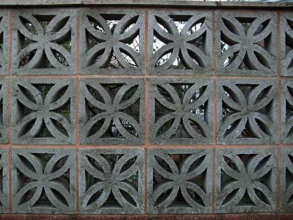 Decorative concrete wall with geometric patterns.