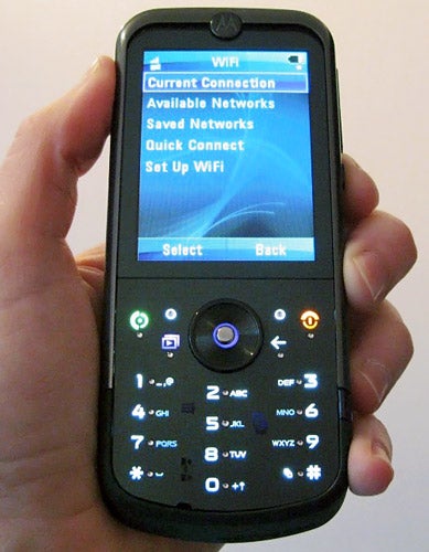 Hand holding Motorola MOTOZINE ZN5 displaying Wi-Fi menu.