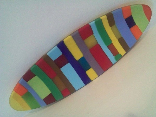 Colorful surfboard on white background.