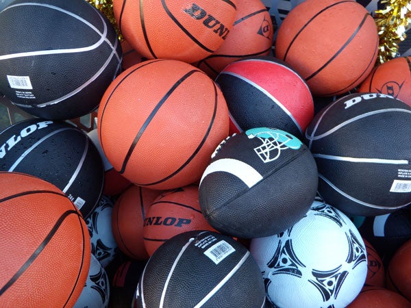 Assorted basketballs in various colors and brands.