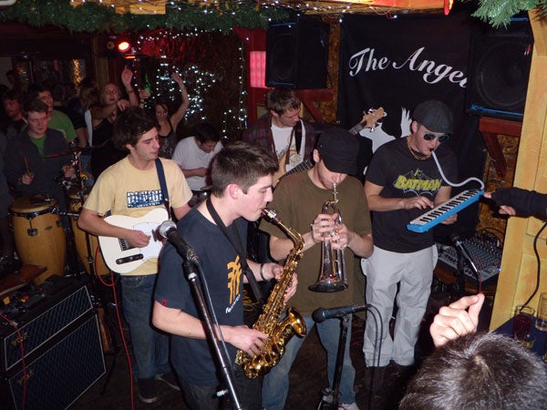 Band performing live music at a crowded venue.
