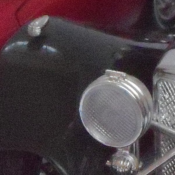 photo of a vintage car's headlamp and grille.