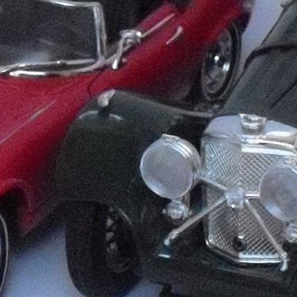 Close-up of miniature red and green vintage cars