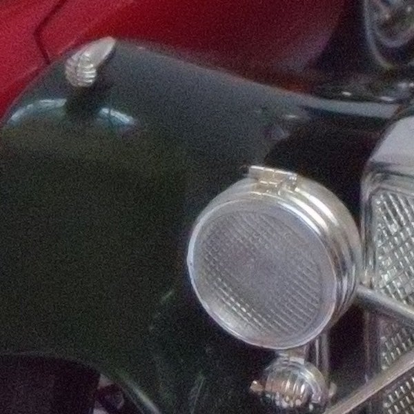 Photo of a vintage car headlight and grille taken with Nikon CoolPix S710.