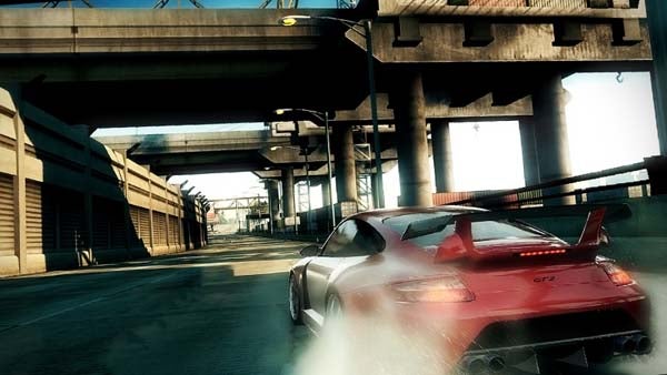 Screenshot from Need for Speed: Undercover video game showing car racing on urban track.