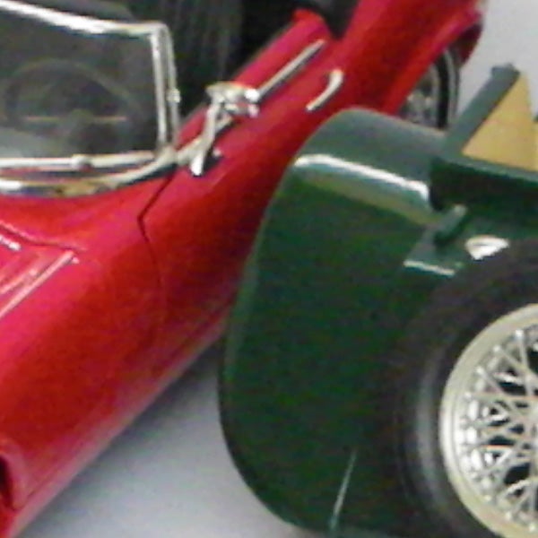 Close-up photo of a red and green toy car.