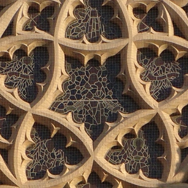Intricate stone lattice work with floral patterns.
