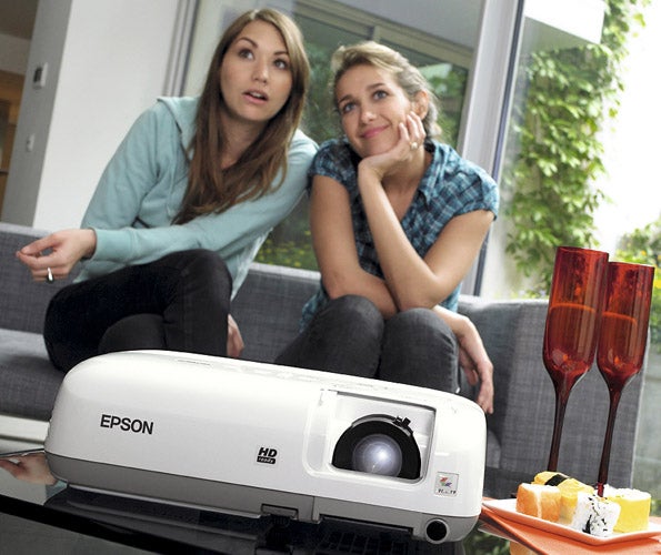 Epson projector with two people in background.