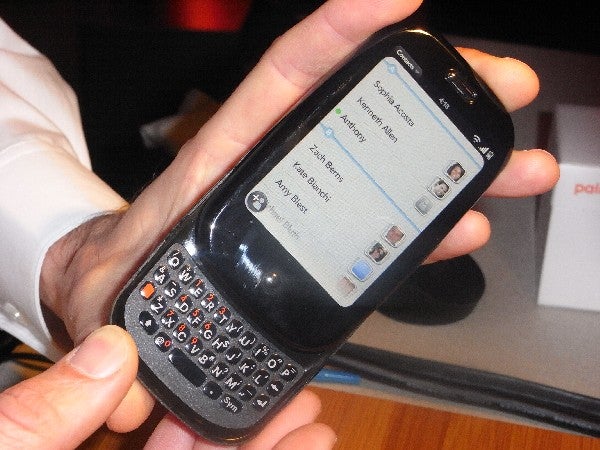 Hand holding a Palm Pre smartphone displaying a message app screen.