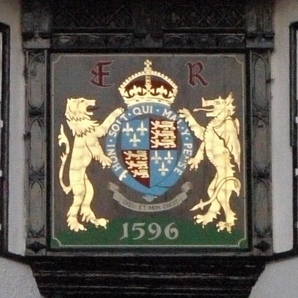Historic crest with lions and crown on building plaque from 1596.