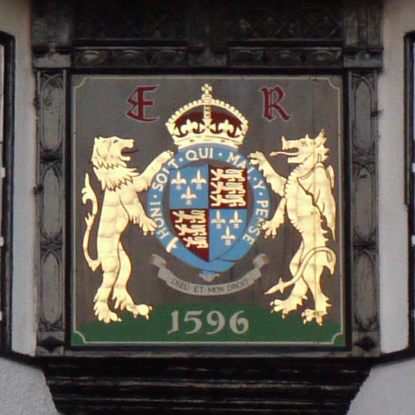 Coat of Arms with lions and a crown displayed on plaque.