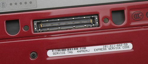 Dell Latitude E4200 laptop with docking station connector and service tag.
