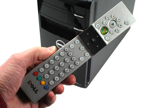 Hand holding a Dell Studio XPS desktop remote control.
