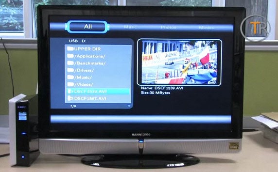 Emtec Movie Cube S800 connected to a TV displaying a media file.