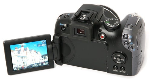 Canon PowerShot SX10 IS camera with flip-out screen displayed.