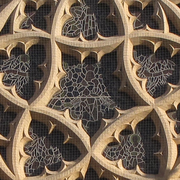 Ornate stone lattice window with intricate designs.