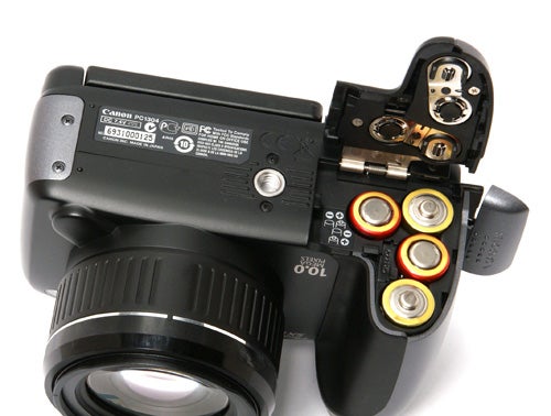 Canon PowerShot SX10 IS camera showing battery compartment.