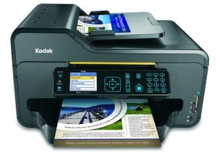 Kodak ESP 9 Printer with control panel display and printed materials.