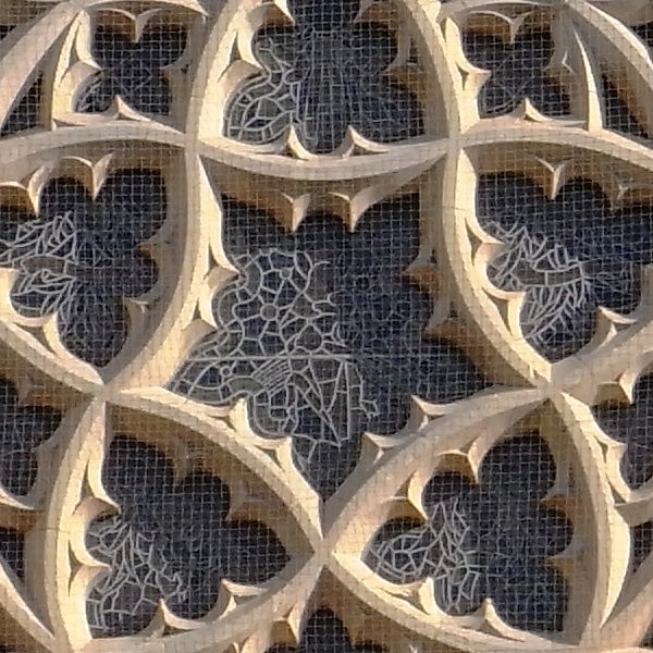 Detailed stone carving patterns on a dark background.