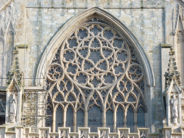 Detailed stone archway of a cathedral facade.
