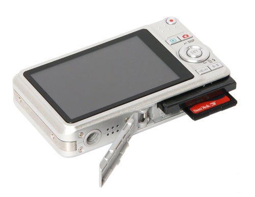 Casio Exilim EX-Z85 camera with open battery compartment.