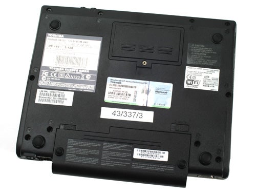 Back view of Toshiba NB100-128 netbook with labels and stickers.