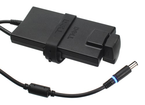 Dell laptop power adapter with glowing LED light.