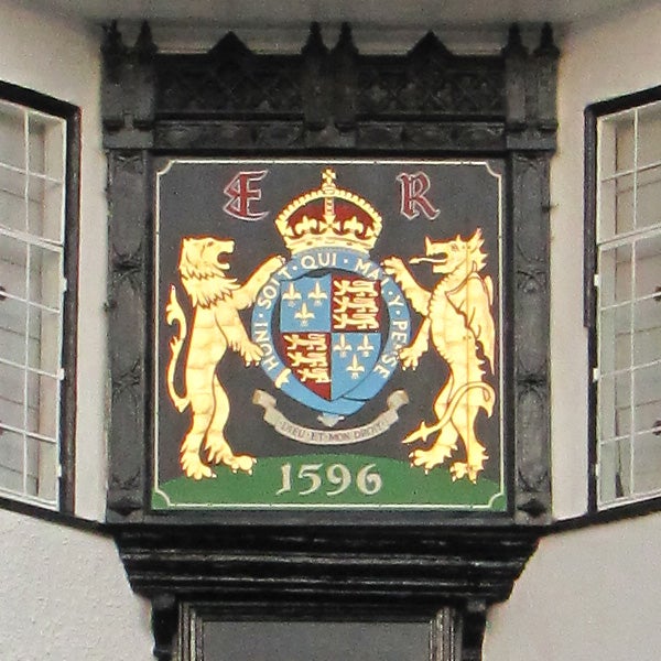 Coat of arms plaque with lions and a crown, dated 1596.
