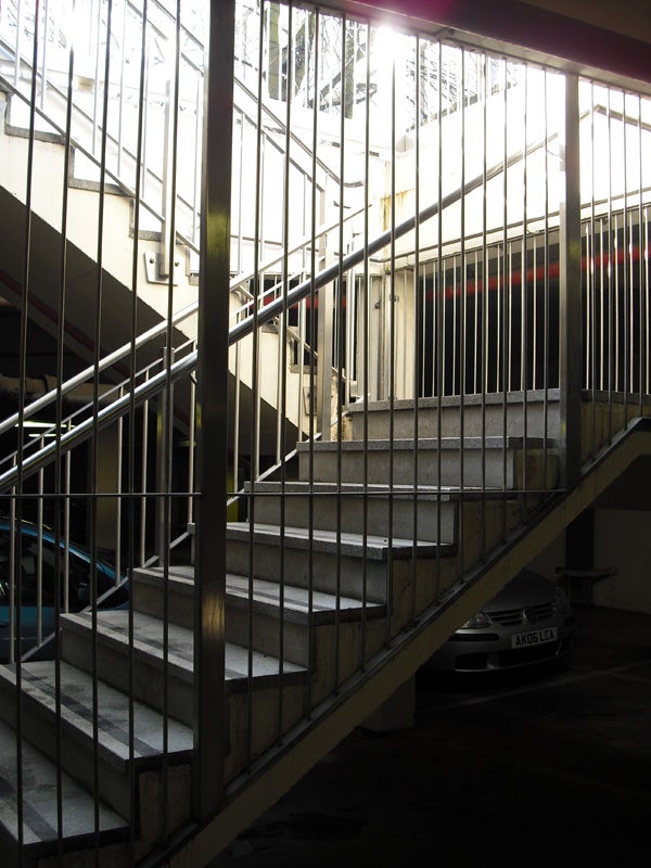 Concrete staircase in a parking garage, slight overexposure.