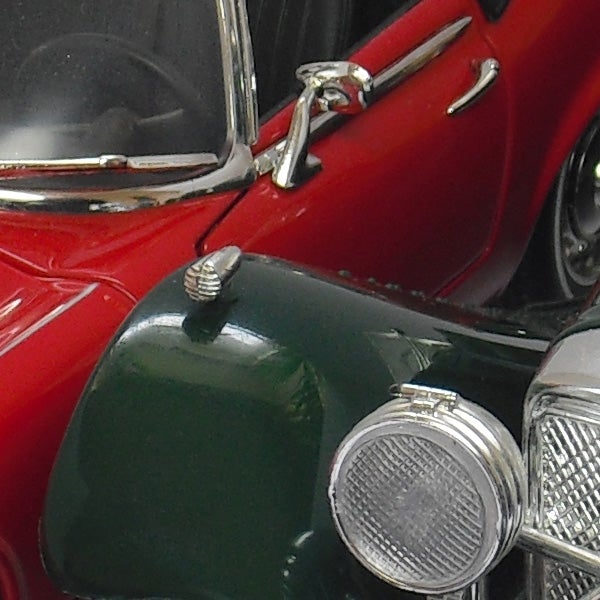 Close-up of a vintage red and green car model