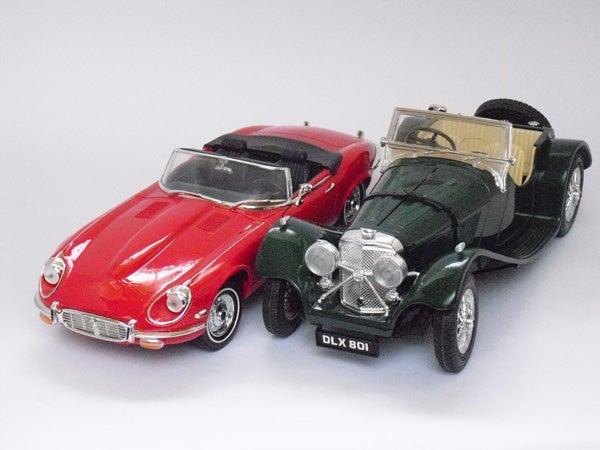 Two vintage model cars on a white background.