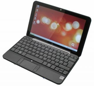 HP Compaq Mini 700 Netbook with open lid displaying screen.