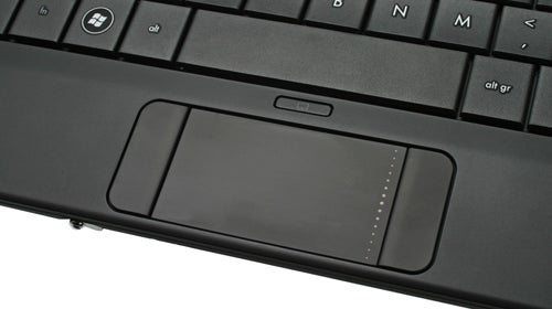 Close-up of HP Compaq Mini 700 netbook touchpad and keyboard.
