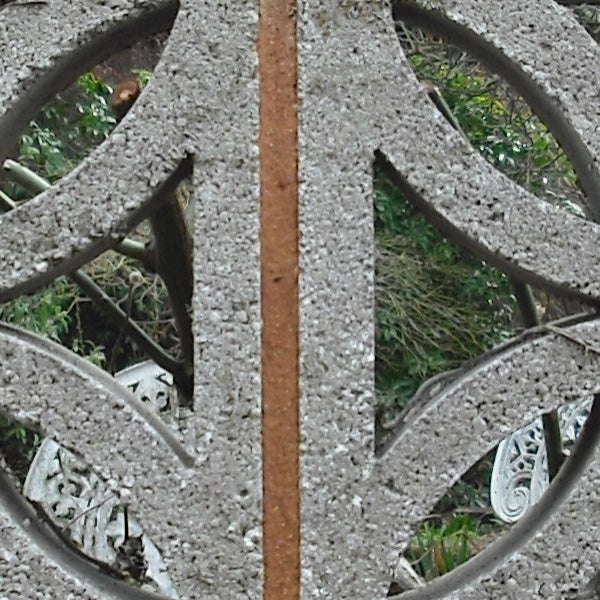 Close-up photo of a rusty metal object with intricate designs.