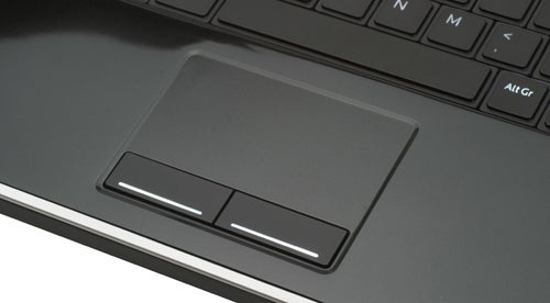 Dell Studio XPS laptop touchpad and keyboard close-up.