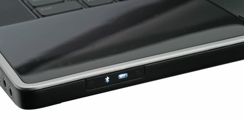 Close-up of Dell Studio XPS 16 laptop edge with ports and logo.
