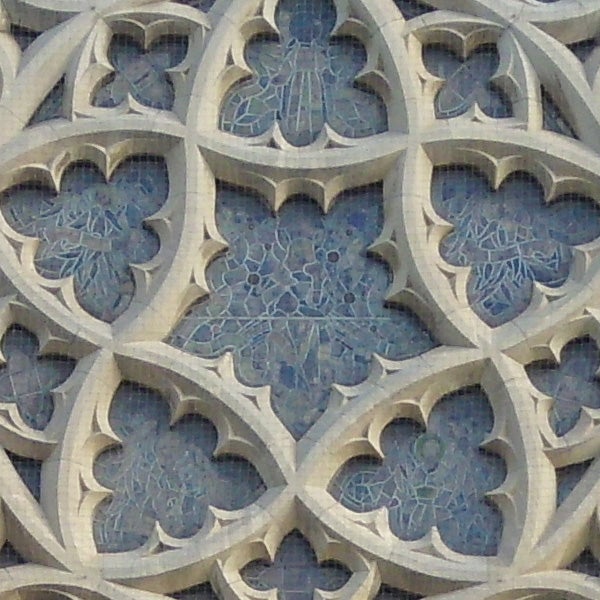 Intricate stone lattice work on a building facade.