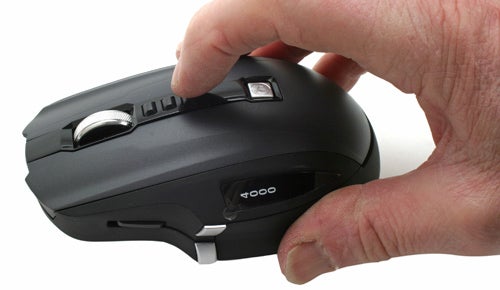 Hand holding Microsoft SideWinder X8 gaming mouse.