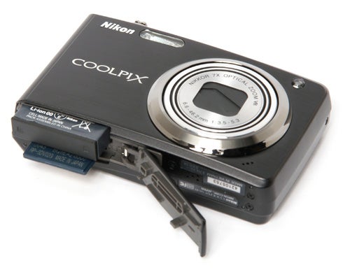 Nikon CoolPix S630 camera with open battery compartment.
