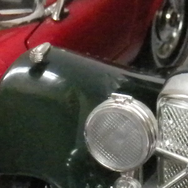 Close-up photo of a classic green car model.