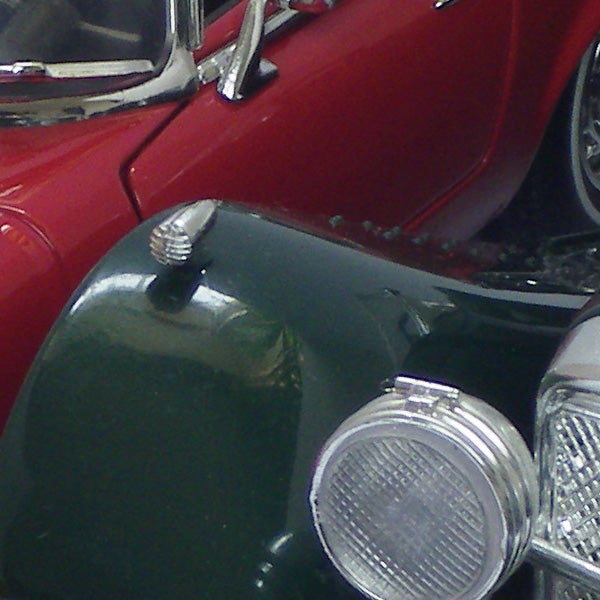 Close-up of a vintage red and green model car