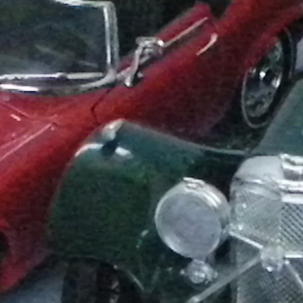 image of vintage red and green cars.