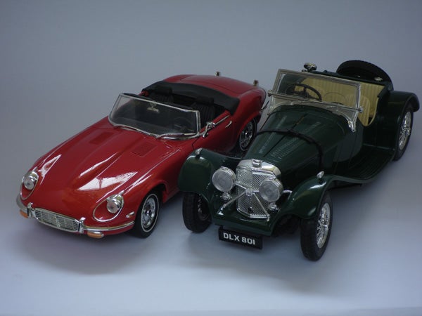 Two vintage model cars on a white background.