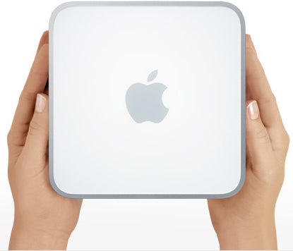 Hands holding an Apple Mac mini computer with an nVidia 9400M logo.